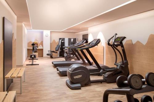 a gym with a bunch of treadmills and ellipticals at Le Massif Hotel & Lodge Courmayeur The Leading Hotels of the World in Courmayeur