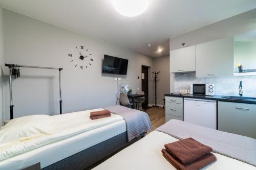 a hotel room with two beds and a kitchen at Svečių namai Imperija in Šiauliai