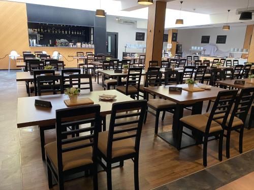 a dining room with wooden tables and chairs at Tatralandia Chatka SnoWiki in Liptovský Mikuláš