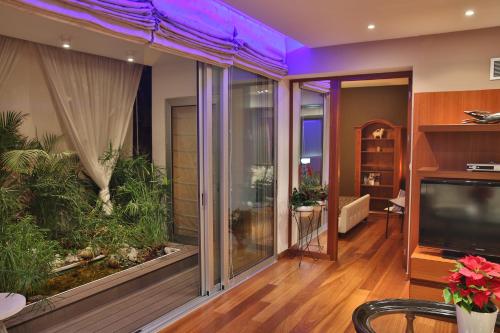 a living room with a large window with a aquarium at Sofouli Suites in Nicosia