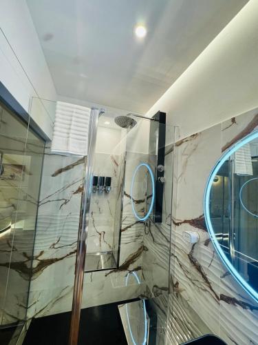 a bathroom with a shower and a glass wall at B&B Amo' in Forlì