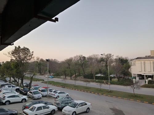 a group of cars parked in a parking lot at Pak Guest House in Dargai