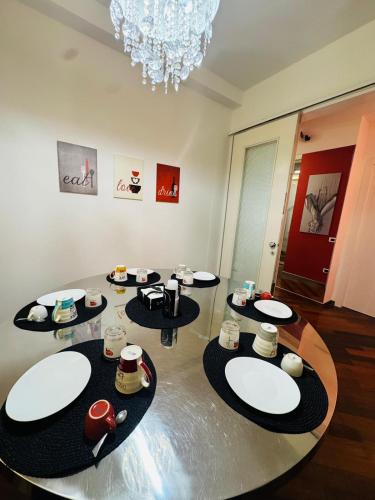 a dining room with a table with plates on it at B&B Amo' in Forlì