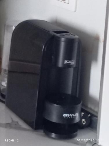 a black coffee maker sitting on a shelf at The Guest Apartment 2025 in Fier