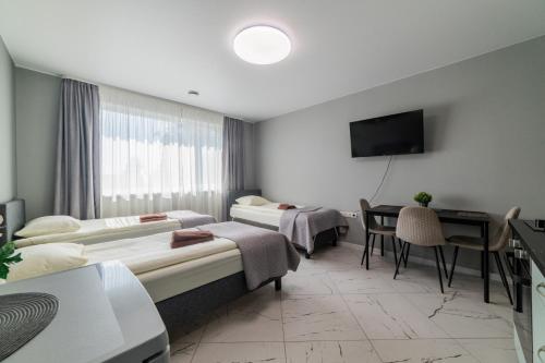 a hospital room with two beds and a table at Svečių namai Imperija in Šiauliai