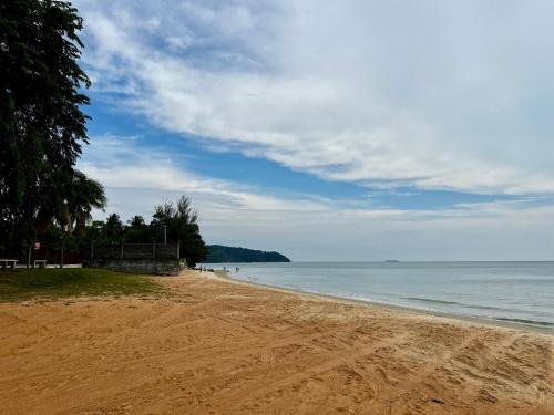 a sandy beach with a view of the ocean at The Rina Homestay-Whole Villa with Private Pool,BBQ & Karaoke-Near Beach- in Port Dickson