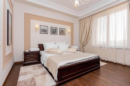 a bedroom with a large bed and a window at Best Western Plus Atakent Park Hotel in Almaty