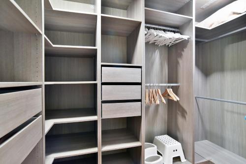 a walk in closet with wooden shelving at Castel Dolais - Magnifique Manoir pour 8p in Saint-Onen-la-Chapelle