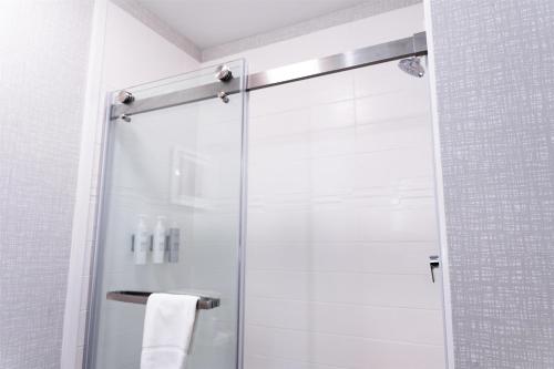 a shower with a glass door in a bathroom at Hampton Inn Turnersville in Blackwood