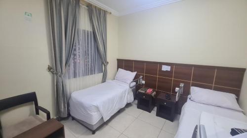 Postel nebo postele na pokoji v ubytování فندق لؤلؤة الشروق