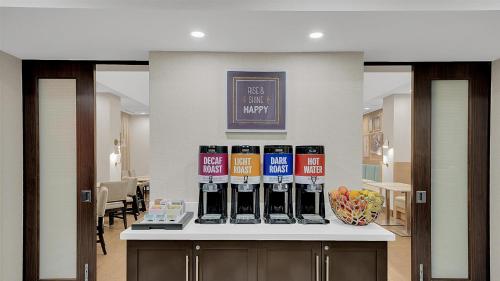 a counter with a bunch of wine bottles on it at Hampton Inn & Suites by Hilton Toronto Markham in Markham