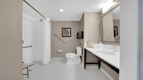 a white bathroom with a toilet and a sink at Hampton Inn & Suites by Hilton Toronto Markham in Markham