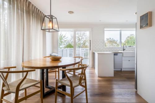 a kitchen and dining room with a wooden table and chairs at La Belle Vie - Boutique Country Escape near Wineries in Red Hill