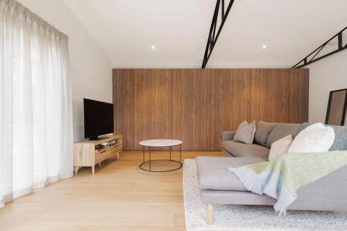 a living room with a couch and a tv at La Belle Vie - Boutique Country Escape near Wineries in Red Hill