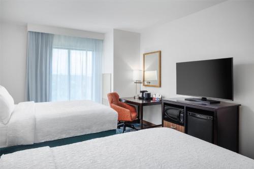 a hotel room with two beds and a desk with a television at Hampton Inn & Suites Chattanooga/Hamilton Place in Chattanooga