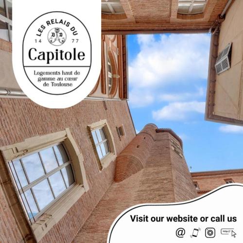 a picture of a building with a sign that says visit our website or call us at Les Relais du Capitole - Appartements d'hôtes in Toulouse