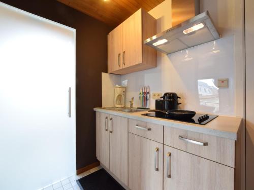a kitchen with a sink and a counter top at Apartment in Champlon Ardenne in Champlon