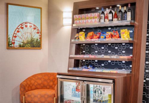 a bar in a hotel room with a chair and wine bottles at Hampton Inn Portland East in Portland