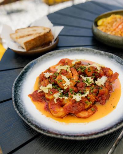 a plate of food with shrimp and bread on a table at DoubleTree by Hilton Wroclaw in Wrocław