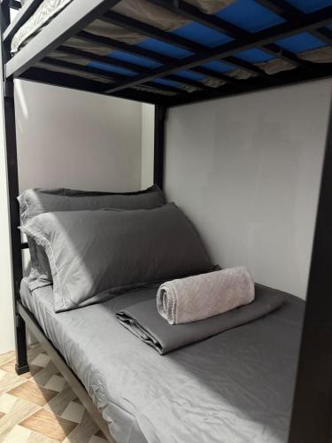 a bed in a room with a bunk bed with blue ceilings at Dive House by Casita del Mabini in Mabini