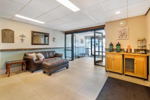 a living room with a couch and a table at Quality Inn at Bangor Mall in Bangor