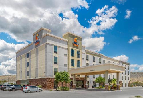 a hotel building with cars parked in a parking lot at Comfort Suites of Las Cruces I-25 North in Las Cruces