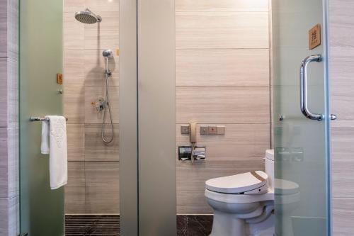 a bathroom with a toilet and a shower at Jinling Grand Hotel in Hefei