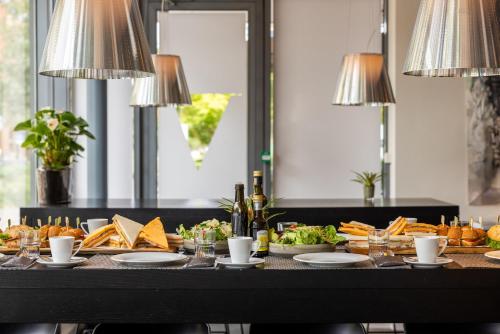 a table filled with food and glasses of wine at Pullman Eindhoven Cocagne in Eindhoven