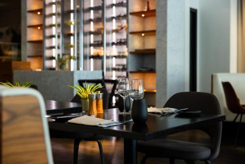 a table in a restaurant with wine glasses at Pullman Eindhoven Cocagne in Eindhoven