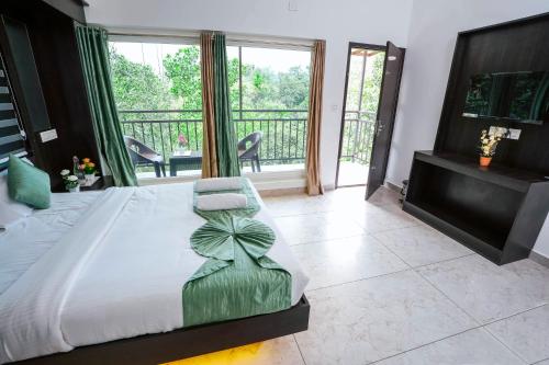 a bedroom with a large bed with a large window at Moonveil Premium Villa Munnar in Anachal
