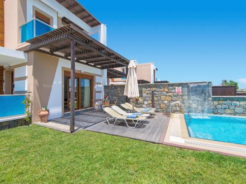 a villa with a swimming pool and a house at Holiday home in Kiotari near the beach in Kiotari