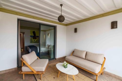 a living room with two chairs and a coffee table at Jaal Riad Resort in Marrakech