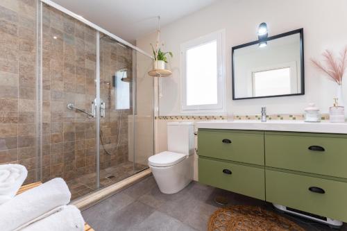 a bathroom with a shower and a toilet and a sink at Villa Sueños in Mijas