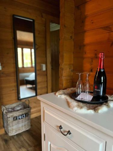 a bottle of wine sitting on top of a dresser at Chalet Du Val 53 in Durbuy
