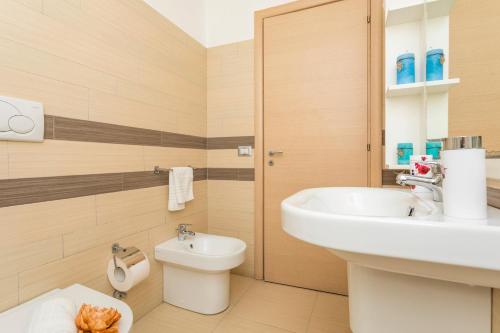 a bathroom with a sink and a toilet at Sirina Tao Beach in Taormina
