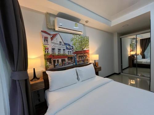 Ένα ή περισσότερα κρεβάτια σε δωμάτιο στο Cozy Condotel Maikhao