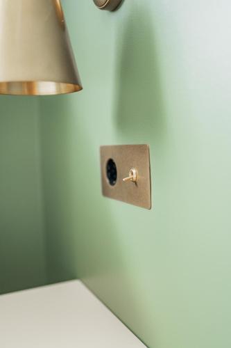 a lightswitch on a wall next to a bed at HOME1 - Augarten City Stay Boutique Hostel in Vienna