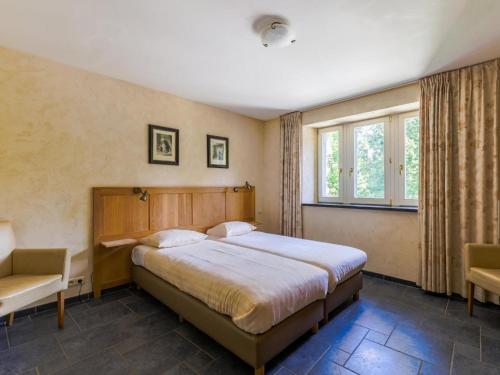 En eller flere senge i et værelse på Castle Apartment in Aywaille near River Amblève