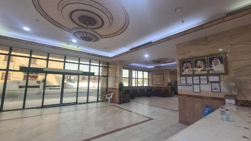 a lobby of a building with a large glass door at فندق جوهرة الشروق in Az Zahrāʼ