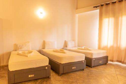 Postel nebo postele na pokoji v ubytování Prana Hotel Ahangama