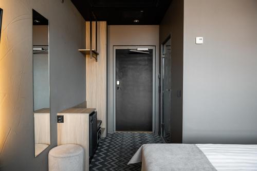 a bedroom with a bed and a glass door at Original Sokos Hotel Puijonsarvi in Kuopio