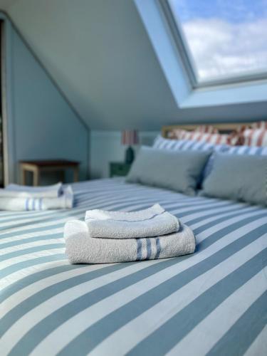 two towels sitting on top of a bed at The Blue Loft in Anstruther