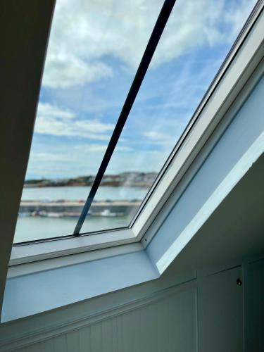 a skylight in a house with a window at The Blue Loft in Anstruther