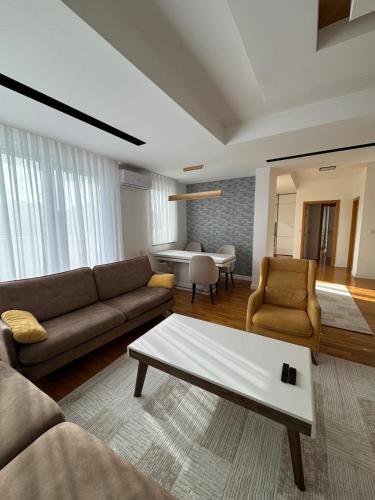 a living room with a couch and a coffee table at Riga Lux Apartment Prishtina in Pristina