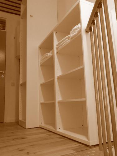 a book shelf in a room next to a staircase at bbrik in Alveringem