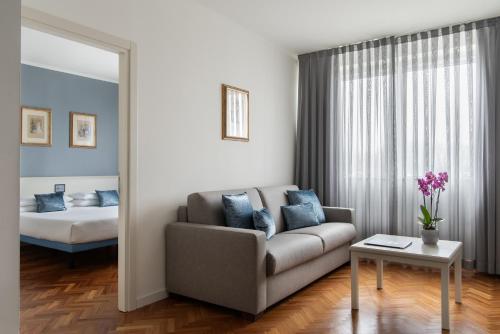 a living room with a couch and a bed at Park Hotel Ripaverde in Borgo San Lorenzo