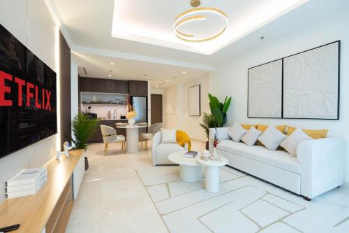 a living room with a white couch and a table at KeyRock - Dubai Marina Stay with Pool & Gym in Dubai