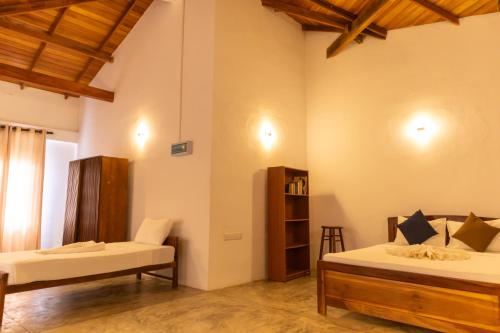 Postel nebo postele na pokoji v ubytování Prana Hotel Ahangama