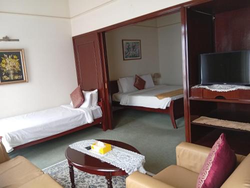 a living room with two beds and a mirror at Fantastic appartment at times square Kuala Lumpur in Kuala Lumpur