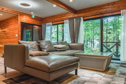a living room with a couch and a table at 森のテラス in Karuizawa